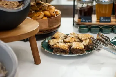 a plate of food on a table with a bowl of bread at Gaia Athens in Athens