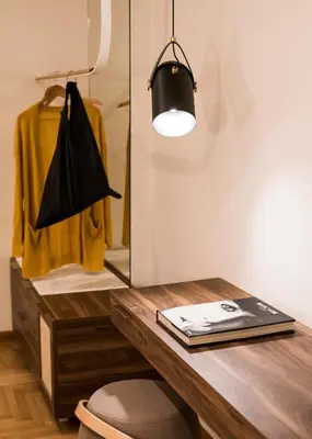 a room with a desk with a book and a lamp at Gaia Athens in Athens