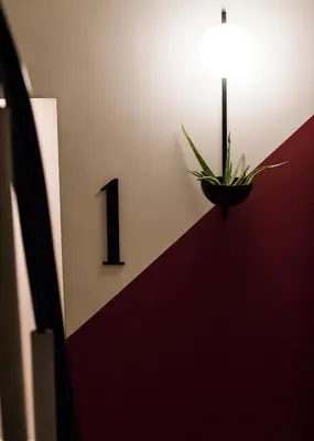 a plant in a pot on a wall with a light at Gaia Athens in Athens