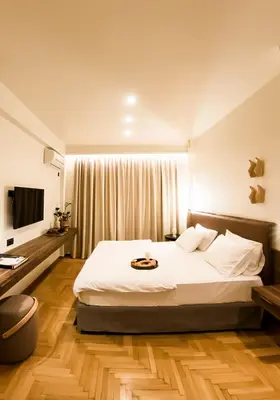 a bedroom with a large bed and a television at Gaia Athens in Athens