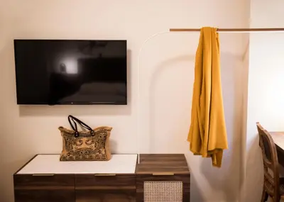 a living room with a tv on a wall and a table at Gaia Athens in Athens