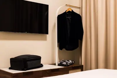 a bedroom with a bed and a black shirt hanging on a curtain at Gaia Athens in Athens