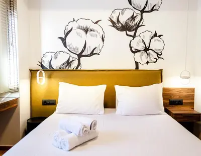 a bedroom with a bed with towels on it at Gaia Athens in Athens