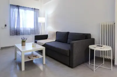 a living room with a couch and a table at Athens One Apartment by Olala Homes in Athens