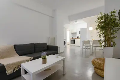a living room with a couch and a table at Athens One Apartment by Olala Homes in Athens