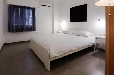 a bedroom with a white bed and a desk at Athens One Apartment by Olala Homes in Athens