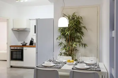 a dining room with a table and chairs and a kitchen at Athens One Apartment by Olala Homes in Athens