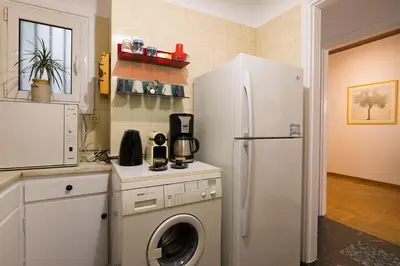 a kitchen with a refrigerator and a washing machine at Your home @Acropolis Museum in Athens