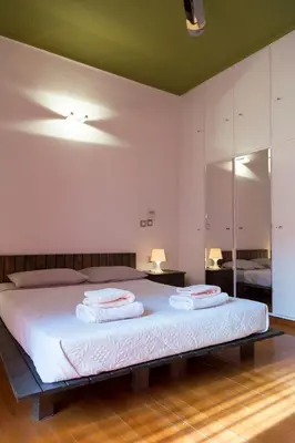 a bedroom with a bed with two towels on it at Your home @Acropolis Museum in Athens