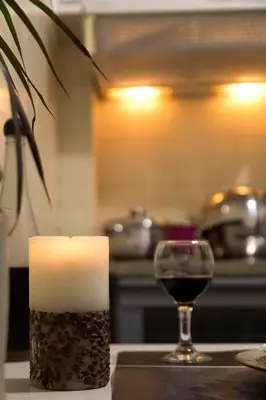 a candle and a glass of wine on a counter at Your home @Acropolis Museum in Athens
