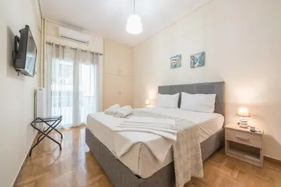 a bedroom with a large bed and a television at Elegant Home in Quiet Street by Cloudkeys in Athens