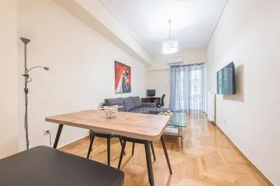 a living room with a table and a couch at Elegant Home in Quiet Street by Cloudkeys in Athens