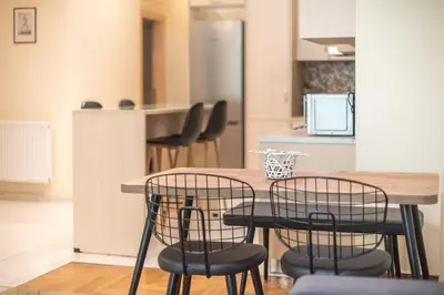 a kitchen with a wooden table and chairs at Elegant Home in Quiet Street by Cloudkeys in Athens