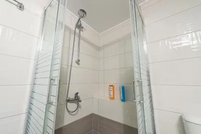 a shower with a glass door in a bathroom at Elegant Home in Quiet Street by Cloudkeys in Athens