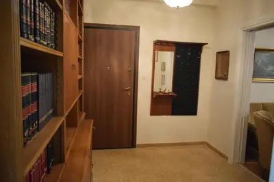 a hallway with a door and a shelf of books at George apartment in Athens