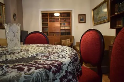 a table with red chairs and a vase on it at George apartment in Athens