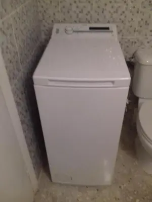a white toilet in a bathroom next to a toilet at George apartment in Athens