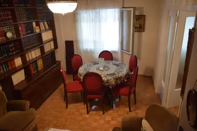 a dining room with a table and red chairs at George apartment in Athens