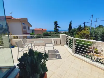 a patio with chairs and a table on a balcony at Summer Villa Lagonissi in Lagonissi