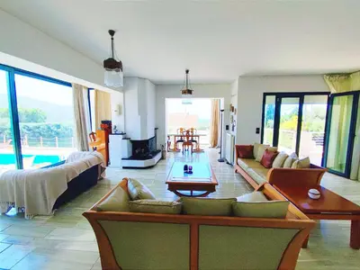 a living room with a couch and a table at Summer Villa Lagonissi in Lagonissi