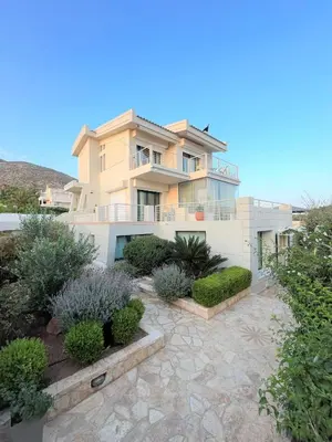 a large white house with a garden in front of it at Summer Villa Lagonissi in Lagonissi