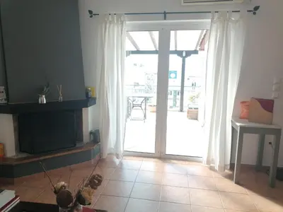 a living room with a sliding glass door to a patio at Center gazi historical in Athens