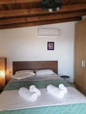 a bedroom with a bed with three towels on it at Center gazi historical in Athens