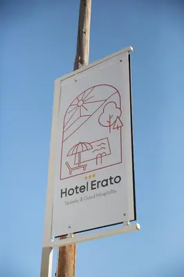 a sign for a hotel erato on a pole at Erato Hotel in Agia Marina Aegina