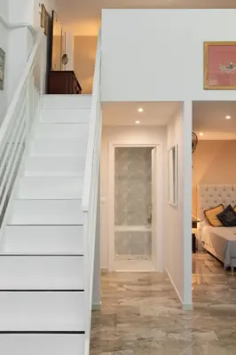 a staircase leading to the bedroom in a house at Acropolis Koukaki Loft Private Garden in Athens