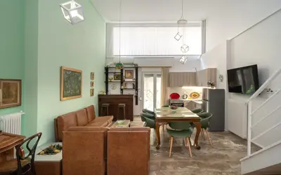 a living room with a couch and a table at Acropolis Koukaki Loft Private Garden in Athens