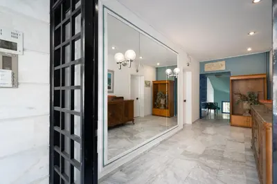 a large mirror in the middle of a hallway at Acropolis Koukaki Loft Private Garden in Athens