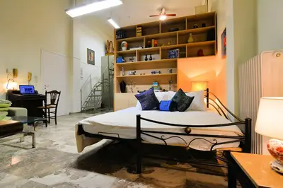 a bedroom with a bed in a room at Acropolis Koukaki Loft Private Garden in Athens