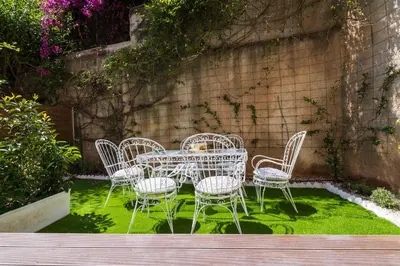a table and chairs sitting on a patch of grass at Acropolis Koukaki Loft Private Garden in Athens
