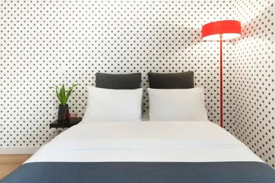 a bedroom with a white bed with a red lamp at Ma Maison No2 Luxury Suite, Parking, 200Mbps,Metro in Athens