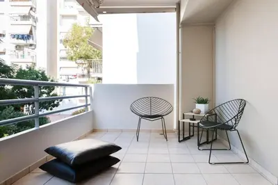 a balcony with two chairs and a table at Ma Maison No2 Luxury Suite, Parking, 200Mbps,Metro in Athens