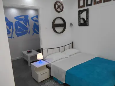 a bedroom with a bed with a blue blanket at Monastiraki flea market & metro station appartment in Athens