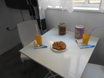 a white table with a plate of cookies and two drinks at Monastiraki flea market & metro station appartment in Athens