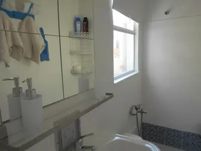 a bathroom with a sink and a mirror at Monastiraki flea market & metro station appartment in Athens