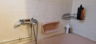 a bathroom with a pink urinal on a wall at Feels Like Home 1 in Athens