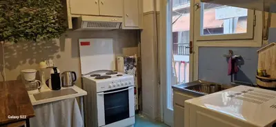 a small kitchen with a stove and a sink at Feels Like Home 1 in Athens