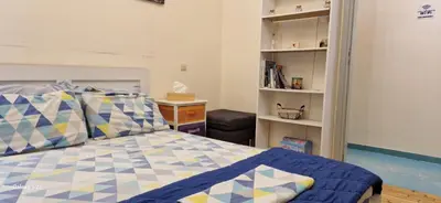 a bedroom with a bed and a book shelf at Feels Like Home 1 in Athens