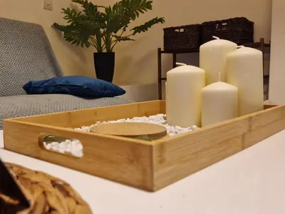 a wooden tray with candles on a table at Feels Like Home 1 in Athens
