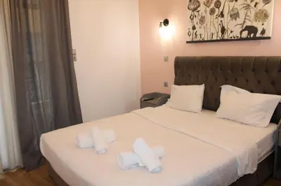 a hotel room with a bed with towels on it at Athens City Themis 2 in Athens