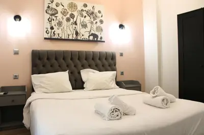 a bedroom with a large bed with towels on it at Athens City Themis 2 in Athens