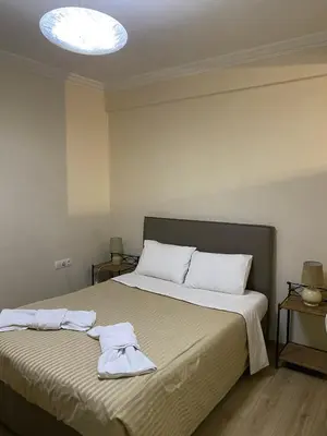 a bedroom with a bed with two towels on it at Athens central apartment in Athens