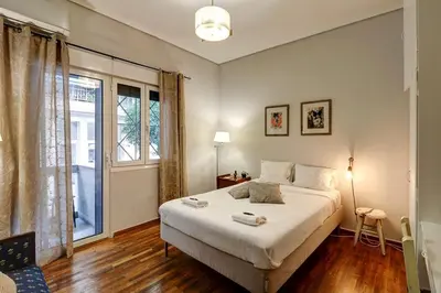 a bedroom with a large bed and a window at Victoria Jewels in Athens