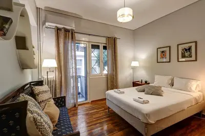 a bedroom with a large bed and a window at Victoria Jewels in Athens