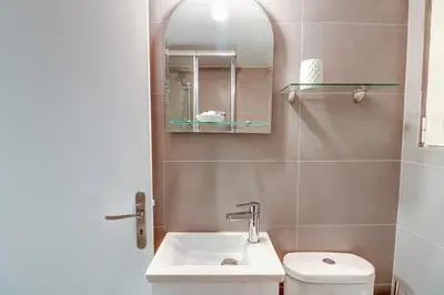 a bathroom with a sink and a toilet and a mirror at Victoria Jewels in Athens
