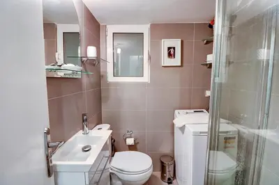 a bathroom with a toilet and a sink and a shower at Victoria Jewels in Athens