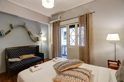 a bedroom with a bed and a window at Victoria Jewels in Athens